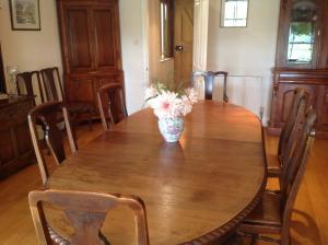 a vase of flowers sitting on top of a wooden table at The Martins B&B in Chelsworth +13 photos