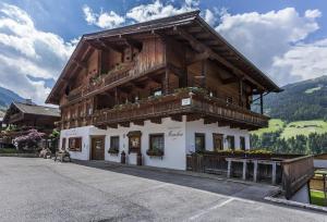 a large wooden building with a balcony at Appartement Moaeben - Panorama in Alpbach