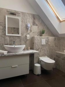 a bathroom with a sink and a toilet at Villa Corner in Tihany +64 photos