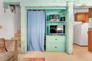 a living room with a blue cabinet and a couch at Year Round Condo- Sleeps 5! - Tamarack #17 in Bear Valley