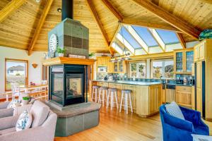 a kitchen and living room with a fireplace in a house at Pelican House in Fort Bragg