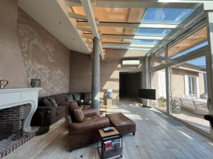 a living room with a couch and a fireplace at Brissago: Villa Claudia in Brissago