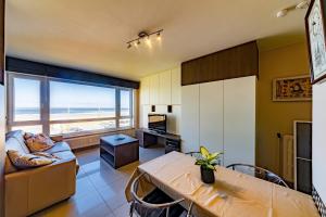 a living room with a view of the ocean at Splendid Seaview - Ostend Luxury Studio 4 persons at beach and sea in Ostend