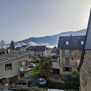 a city with cars parked in a parking lot at LAMATACAM, T3, RDC, 2 chamb. centre Argelès Gazost in Argelès-Gazost