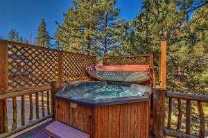 a hot tub on the deck of a house at 015 - Hidden Bridge Cabin in Big Bear Lake