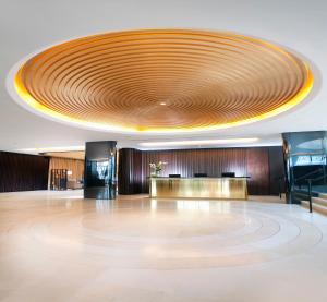 a large lobby with a large circular ceiling at Dorsett Shepherds Bush London in London