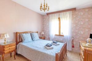 a bedroom with a bed and a chandelier at Nice Duplex With Garden Terrace And Garage in Six-Fours-les-Plages