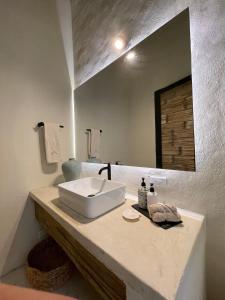 a bathroom with a white sink and a mirror at Casa De Amigos Hotel Boutique in Honda
