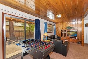 a living room with a pool table in the middle at 049 - Mountain Time in Big Bear Lake