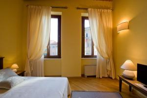 Posteľ alebo postele v izbe v ubytovaní Piazza Azuni 18 Guest House