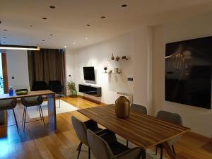 a living room with a wooden table and chairs at Residencial Gijón Centro in Gijón