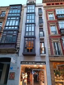 una tienda frente a un edificio con ventanas en Residencial Gijón Centro en Gijón