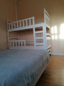 a bedroom with two bunk beds and a bed at Eichis Landliebe in Gorschendorf