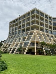 a large building with a grass field in front of it at 71 Kyalanga in Durban