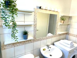 a bathroom with a sink and a mirror and a toilet at Lena Kassiopi Apartments in Kassiopi