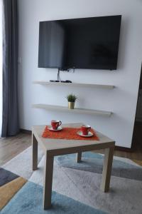 a coffee table in a living room with two cups at Apartman Borovi 14 in Divčibare