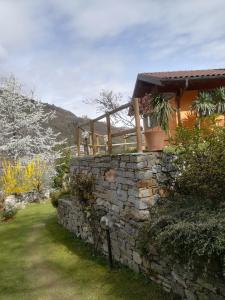 a stone wall in front of a house at Cascina nel Bosco in Cannobio