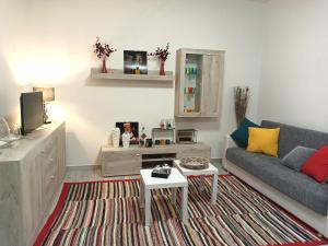 a living room with a couch and a table at LA CASA DI FRANCESCO in Putifigari