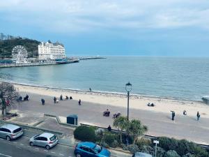 a beach filled with lots of cars and boats at Merrion Hotel in Llandudno