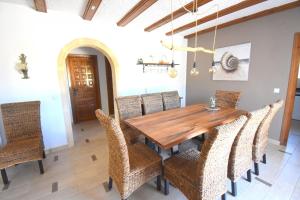 a dining room with a wooden table and chairs at Casa la Selva Javea - 5043 in Jávea