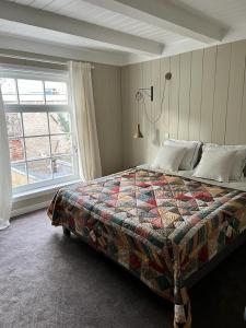 a bedroom with a large bed and a window at Dahli's Sleep Boutique in Amsterdam