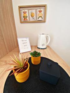 a table with two potted plants and a coffee maker at The Manzoni family 5 in Punat