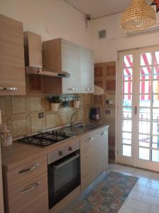 a kitchen with a stove and a sink at Dream Travel Home in Formia