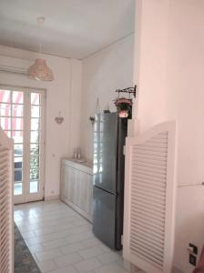 a kitchen with a stainless steel refrigerator in a room at Dream Travel Home in Formia