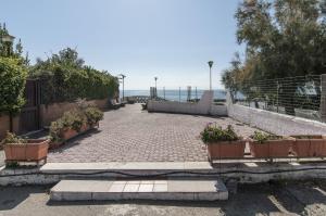 a brick walkway with potted plants on it at Dream Travel Home in Formia