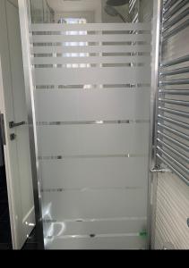 a shower with a glass door in a bathroom at L'isola di Kalyta in Lido di Ostia