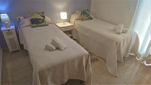 Voodi või voodid majutusasutuse Cerca playa-AA-Patio privado toas