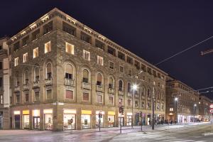 a large brick building on a city street at night at Five stars Florence luxury apartments in Florence