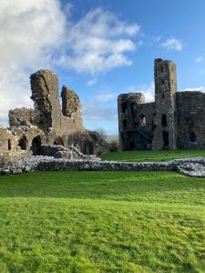 an old castle in the middle of a field at St Martin’s view in Haverfordwest