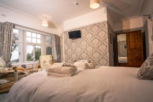 a bedroom with a large bed with towels on it at Foyers Bay Country House in Foyers