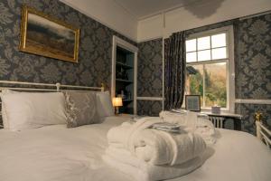 a bedroom with a bed with towels on it at Foyers Bay Country House in Foyers