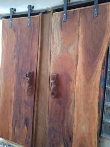 a wooden door with two metal knobs on it at Saldomar B&Biosphere in Bubaque