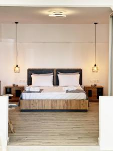 a bedroom with a large bed with two lamps at Nostos home in Dhragoulás