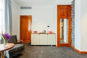 a living room with a couch and a table at Wigram Hotel in Christchurch