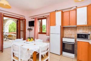 a kitchen with a table with a white table cloth at Epavlis in Methoni