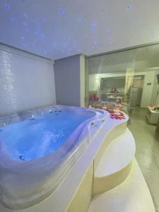 a large bath tub in a room with at Ungaretti Resort in Porto Cesareo