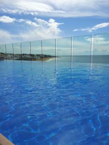 a blue and white ocean with a blue sky at Rocamar Exclusive Hotel & Spa - Adults Only in Albufeira