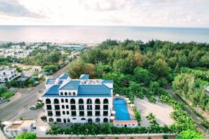 an aerial view of a white building with a blue roof at Hafi Beach Hotel in Vung Tau