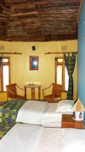 Säng eller sängar i ett rum på Kilimanjaro Eco Lodge