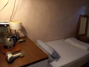 Llit o llits en una habitació de Lima.Tujoh