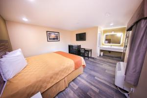 a hotel room with a bed and a desk at GAREY MOTEL in Pomona