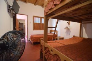a bedroom with two bunk beds and a fan at Mamaqocha in Canoas de Punta Sal +176 photos