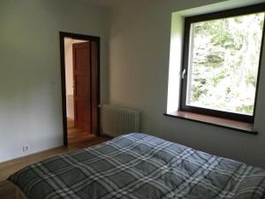 a bedroom with a bed and a large window at Triglav Park House in Bled