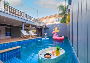 a swimming pool with a pool toy in the water at 4 Bedroom Town Villa With Private Pool in Pattaya South