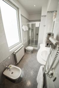 a bathroom with a toilet and a sink at Residence Victoria in Trieste +19 photos