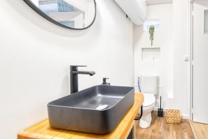 a bathroom with a black sink and a toilet at Bien-être et bonheur au pied des Thermes in Allevard +12 photos